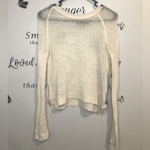 tight knit a sweater. It is stretchy It will have a semi tight/loose fit.